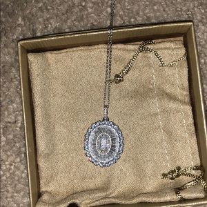 Oval pendant necklace with shimmering gemstones